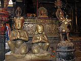 Kathmandu Patan Golden Temple 29 Statue Of King And Queen Close Up Outside Entrance Door To The Swayambhu Chaitya With A Snow Lion And Many Statues 